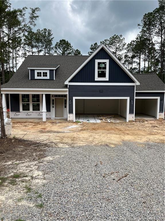 181 Pinecrest Dr, Carthage, NC 28327 - view of front of property with an attached garage, a porch, driveway, and roof with shingles