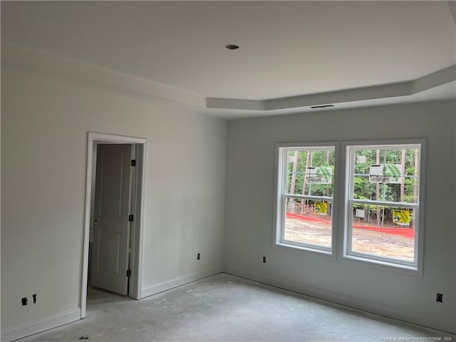 181 Pinecrest Dr, Carthage, NC 28327 - spare room with baseboards, concrete flooring, and a tray ceiling
