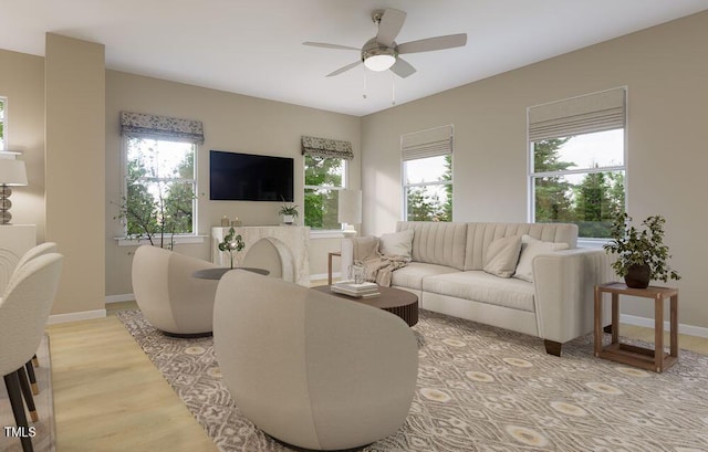 living room featuring ceiling fan and light hardwood / wood-style flooring