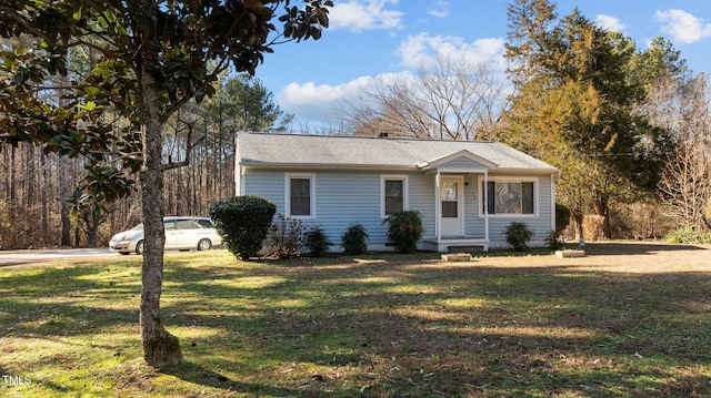 ranch-style home with a front lawn