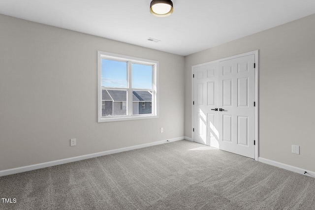 unfurnished bedroom featuring a closet and carpet floors