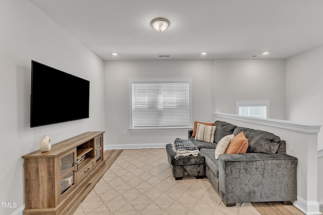 sitting room featuring visible vents, light wood-style flooring, recessed lighting, and baseboards