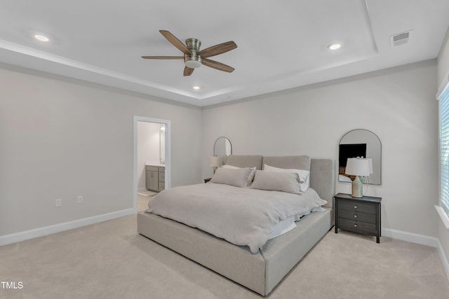 bedroom featuring recessed lighting, light colored carpet, a raised ceiling, and baseboards