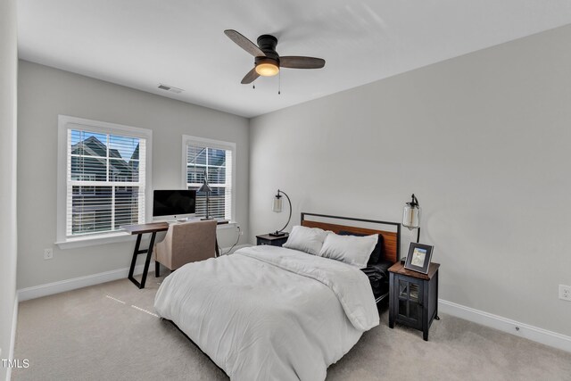 bedroom with ceiling fan, baseboards, visible vents, and light carpet