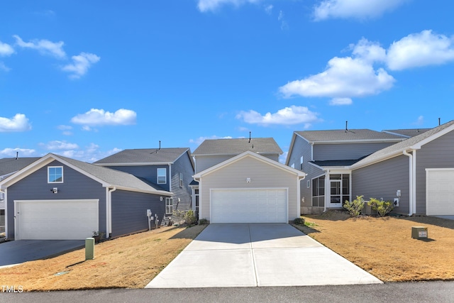 traditional-style house featuring concrete driveway and an attached garage