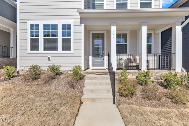 doorway to property featuring covered porch