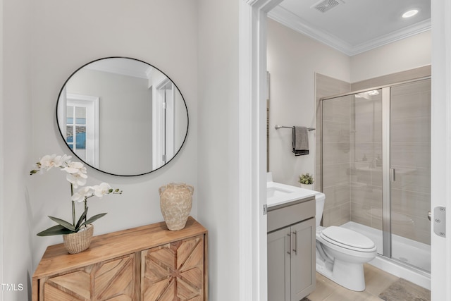 bathroom with vanity, a shower stall, crown molding, and visible vents