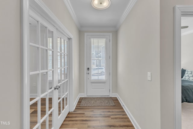 doorway to outside with ornamental molding, french doors, baseboards, and wood finished floors