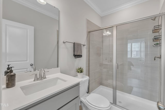 bathroom featuring vanity, crown molding, toilet, and a stall shower