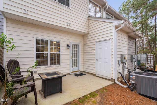 view of patio with a fire pit and central AC unit