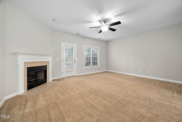 unfurnished living room with ceiling fan and light carpet