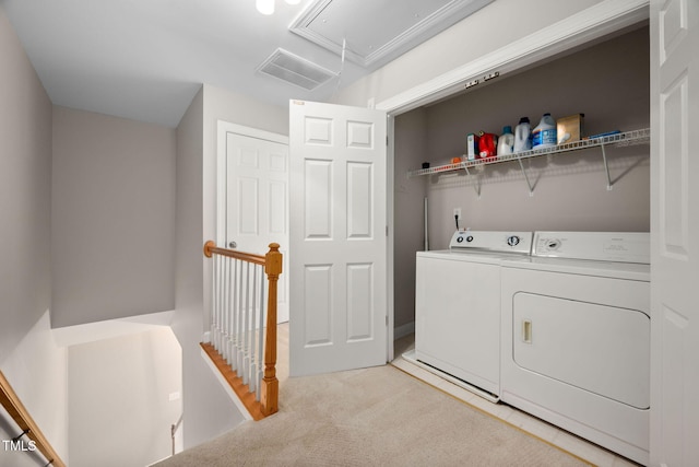 laundry room featuring washer and clothes dryer and light carpet