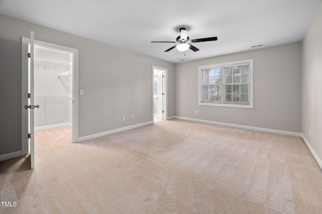 unfurnished room featuring light colored carpet and ceiling fan