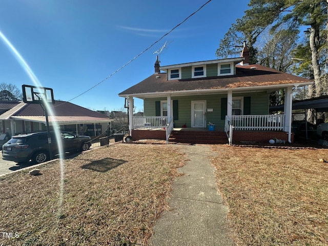 bungalow with covered porch and a front yard