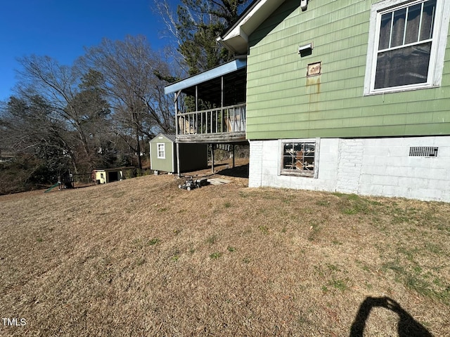 view of property exterior featuring a yard and a storage shed