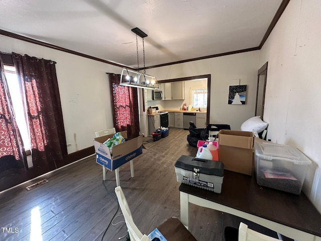 dining area featuring ornamental molding, an inviting chandelier, plenty of natural light, and dark hardwood / wood-style flooring