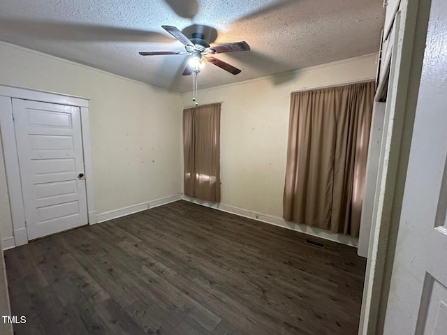 unfurnished bedroom featuring a closet, ceiling fan, dark wood-type flooring, and a textured ceiling