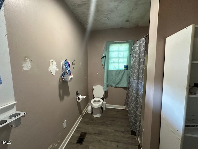 bathroom with toilet and hardwood / wood-style floors