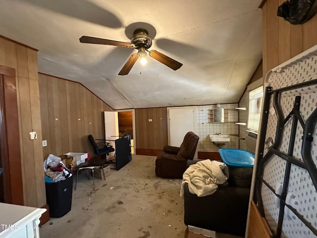 interior space with sink, wooden walls, and lofted ceiling