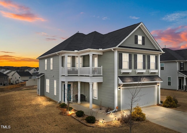 view of front of property with a balcony and a garage