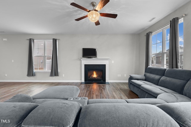 living room with hardwood / wood-style flooring, a healthy amount of sunlight, and ceiling fan