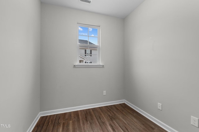 unfurnished room with dark hardwood / wood-style floors