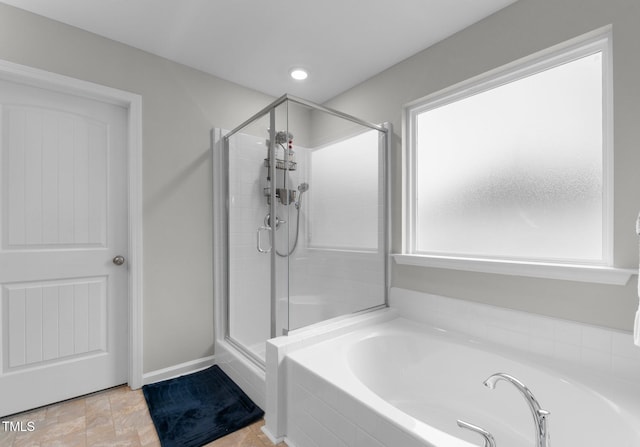 bathroom featuring separate shower and tub