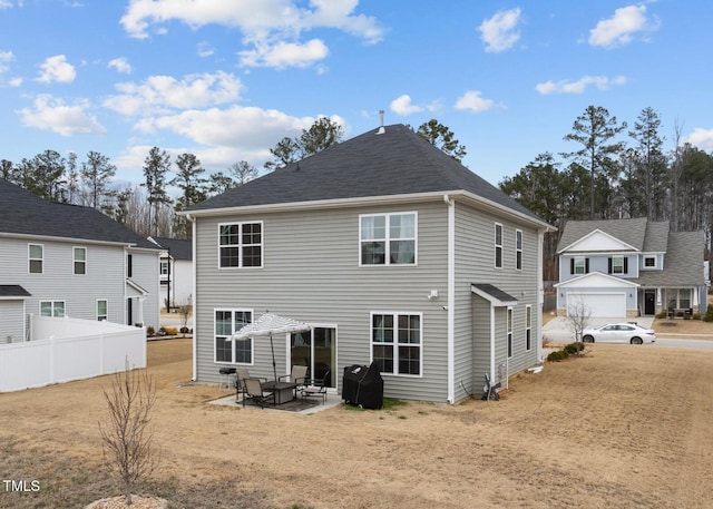 rear view of house featuring a patio and a lawn