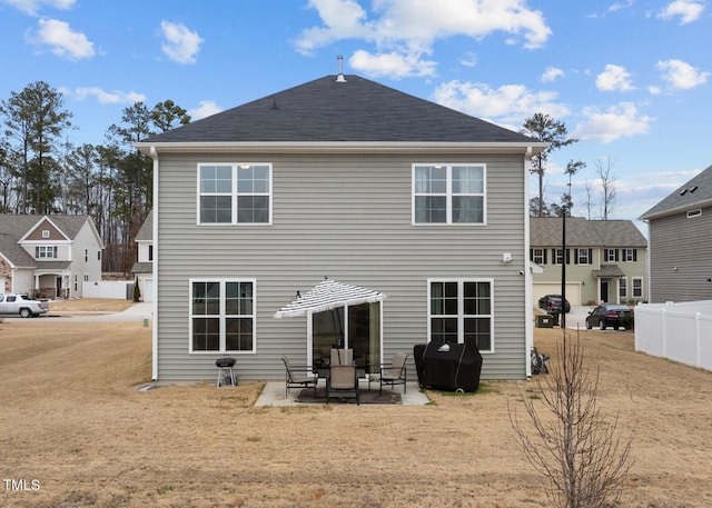 back of property with a patio area and a yard