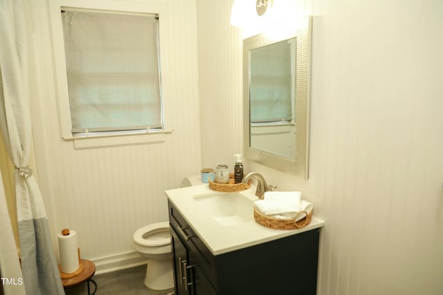 bathroom featuring vanity, wood-type flooring, and toilet