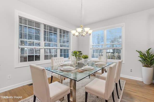 dining area featuring a notable chandelier and hardwood / wood-style floors