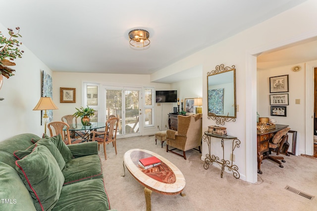 living area with visible vents and carpet floors