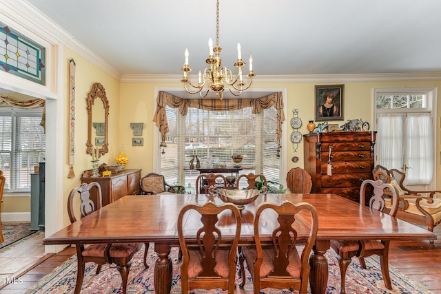 dining space featuring crown molding, a notable chandelier, and wood-type flooring