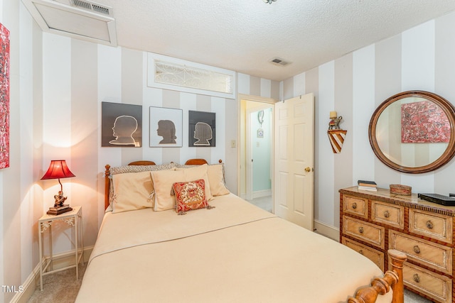 carpeted bedroom featuring a textured ceiling, baseboards, and visible vents