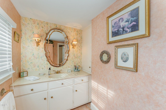bathroom with plenty of natural light, vanity, and wallpapered walls