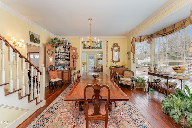 dining space with ornamental molding, stairway, an inviting chandelier, and hardwood / wood-style flooring