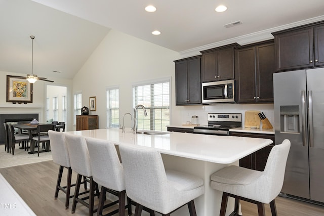 978 Bonanza Ln Unit 163, Mebane, NC 27302 - kitchen with appliances with stainless steel finishes, sink, a kitchen island with sink, and light wood-type flooring