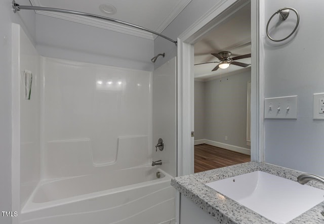 bathroom with crown molding, shower / washtub combination, ceiling fan, and vanity