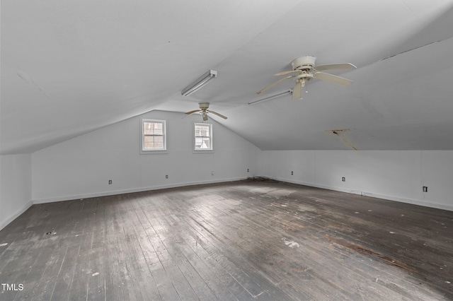 additional living space featuring vaulted ceiling, ceiling fan, and dark hardwood / wood-style flooring