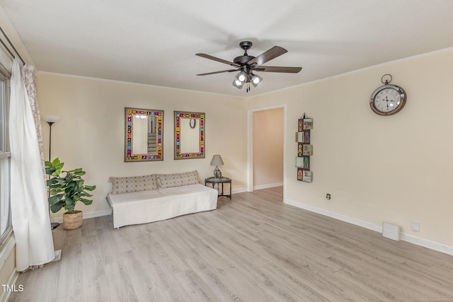 unfurnished room with ornamental molding, ceiling fan, and light wood-type flooring