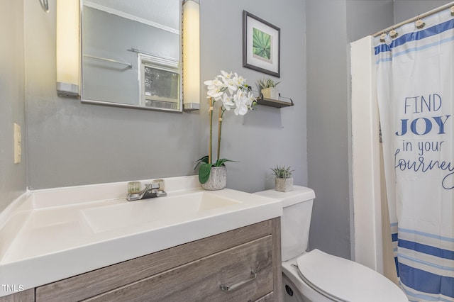 bathroom with ornamental molding, toilet, vanity, and a textured ceiling