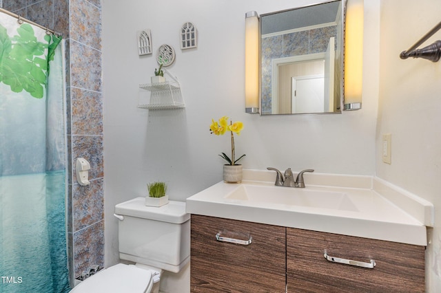 bathroom featuring vanity, toilet, and walk in shower