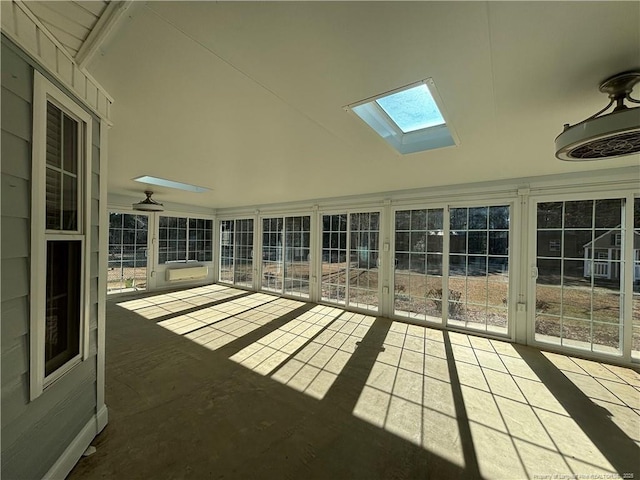 unfurnished sunroom featuring a skylight