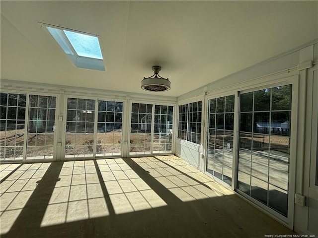 unfurnished sunroom with a skylight