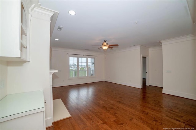 unfurnished living room featuring ceiling fan, baseboards, wood finished floors, and crown molding