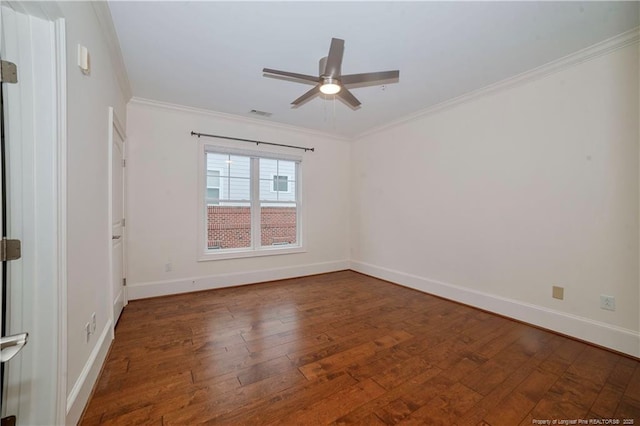 spare room with hardwood / wood-style flooring, visible vents, a ceiling fan, baseboards, and ornamental molding