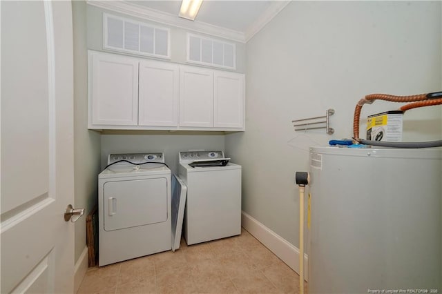 laundry room featuring cabinet space, baseboards, ornamental molding, washing machine and clothes dryer, and gas water heater