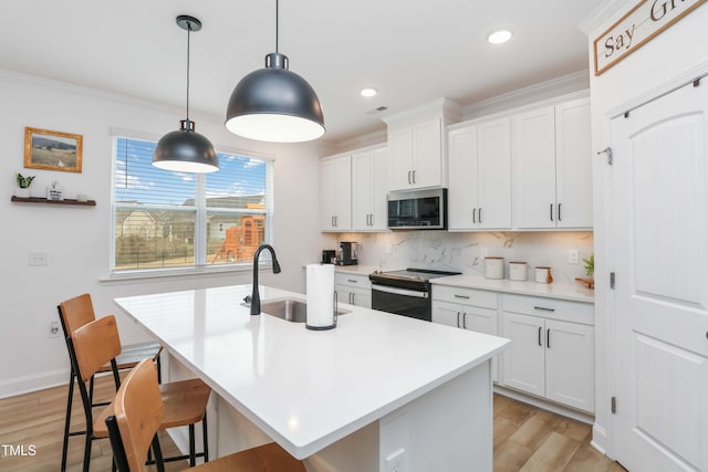 kitchen featuring white cabinetry, sink, electric range, and decorative light fixtures