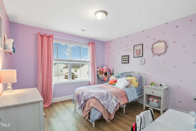 bedroom with light wood-type flooring