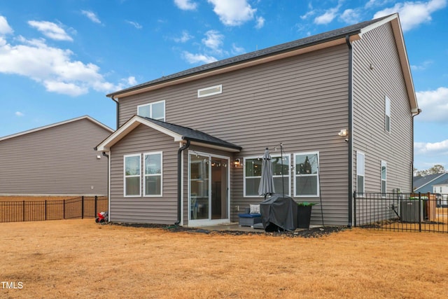 rear view of house featuring a yard and cooling unit